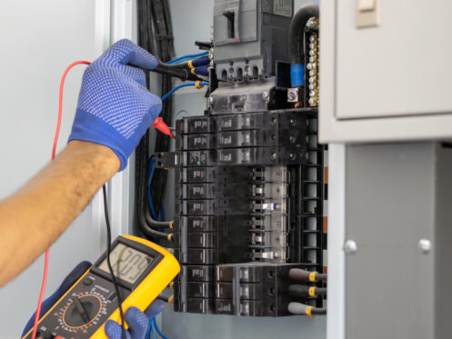 Electrician checking an electrical panel